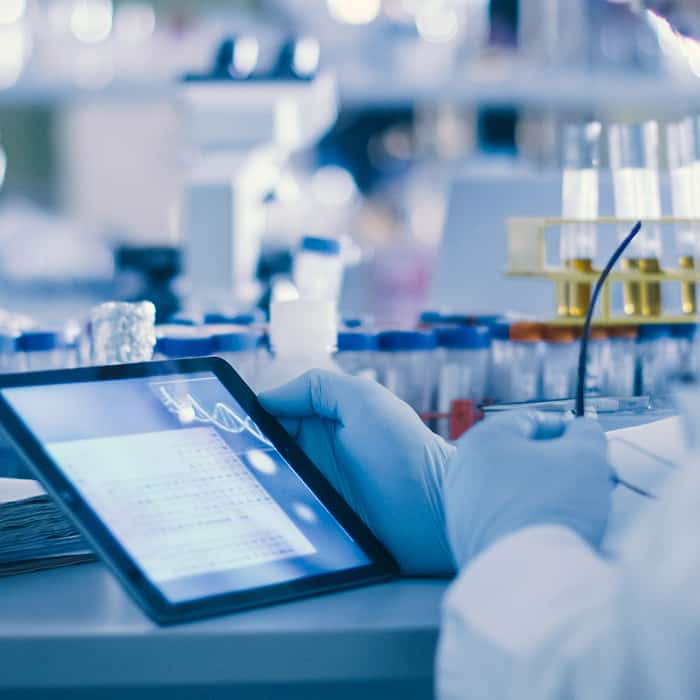 technician looking at tablet in laboratory indianapolis in